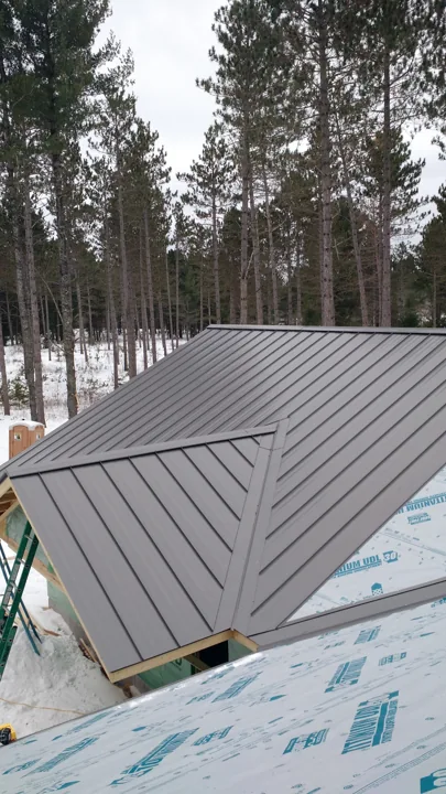 Metal roof installation in a wooded setting