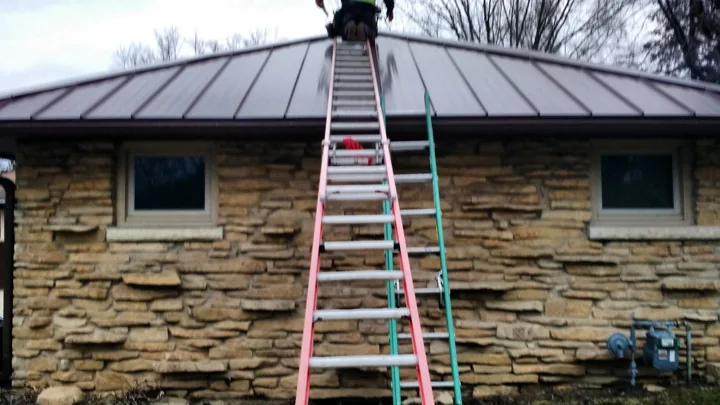 Standing-seam metal roof on a stone house